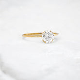 golden-dawn-round-cut-heartbeat-moissanite-engagement-ring-1-ct-yellow-gold-gemfora-2